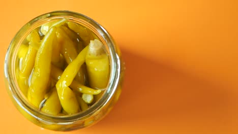 pickled green peppers in a glass jar