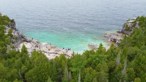 tourists relaxing on rocky shore of georgian bay in ontario, canada