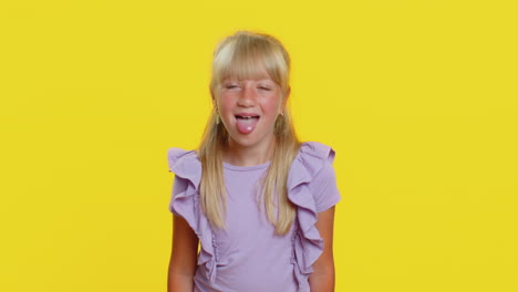 cheerful funny bully child girl showing tongue making silly faces fooling around joking teasing