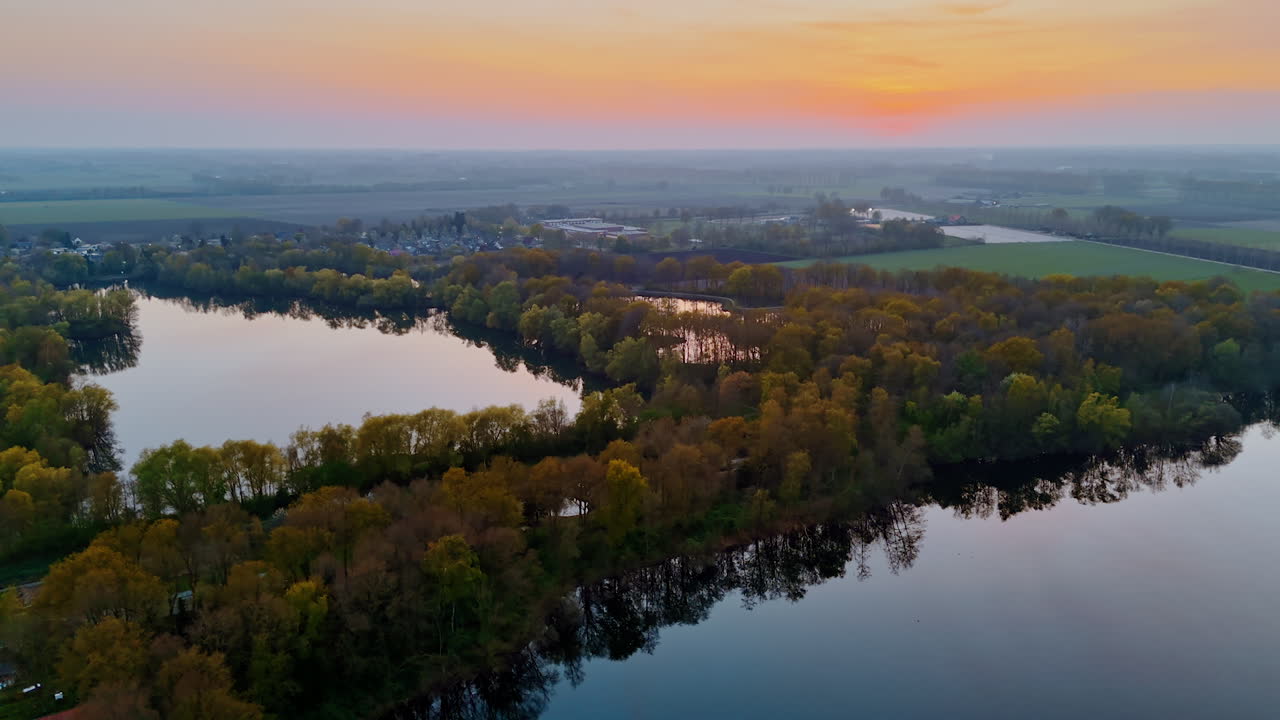 Stunning Dutch sunset view. Aerial view of a serene sunset highlighting rivers and lush greenery in the Netherlands, showcasing natural beauty