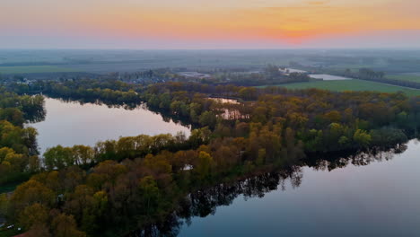 stunning dutch sunset view. aerial view of a serene sunset highlighting rivers and lush greenery in the netherlands, showcasing natural beauty