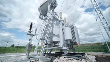 high voltage transformer against the blue sky. electric current redistribution substation