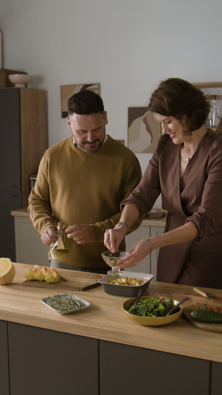 Family cooking salad in the kitchen