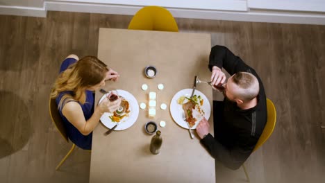 couple toasting glass of wine while having dinner 4k