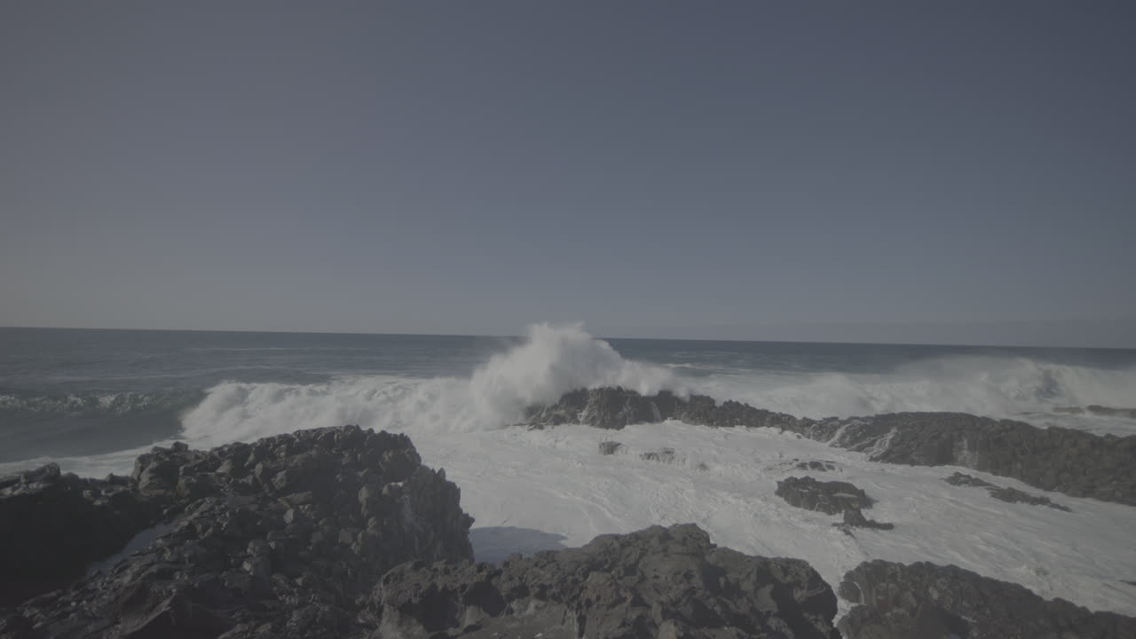 Powerful Waves Crashing on Rocky Coastline