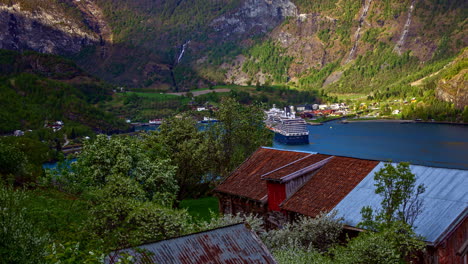 5k time lapse shot of cruise liner docking at port of flam city in norway - beautiful landscape during sunny day with clouds