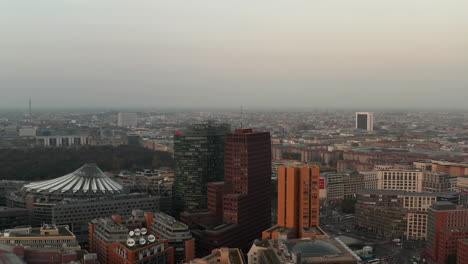 Descending-aerial-view-of-Potsdamer-Platz-neighbourhood.-Sony-center-and-modern-tall-office-towers.-Berlin,-Germany