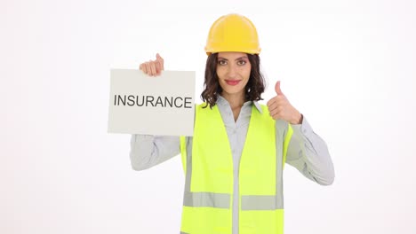 woman in safety vest and hard hat holding an 'insurance' sign and giving a thumbs-up