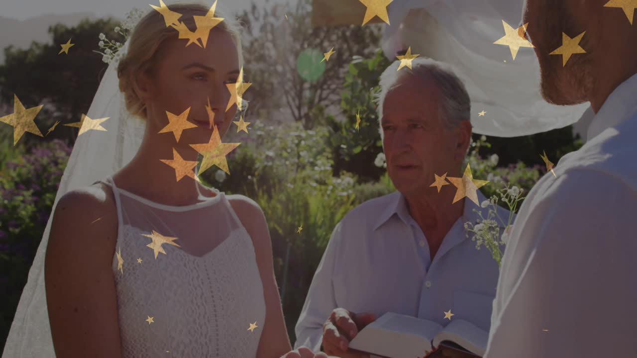 Bride and groom standing outdoors in garden showcasing golden star confetti for wedding design