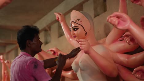 in kumortuli, idol artists are making idols of durga, the revered deity of hinduism. the work of making these idols starts from june and these potters make many idols till november.