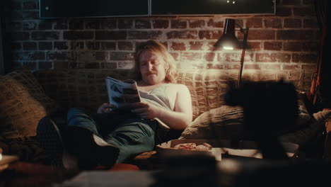 man relaxing on couch at night