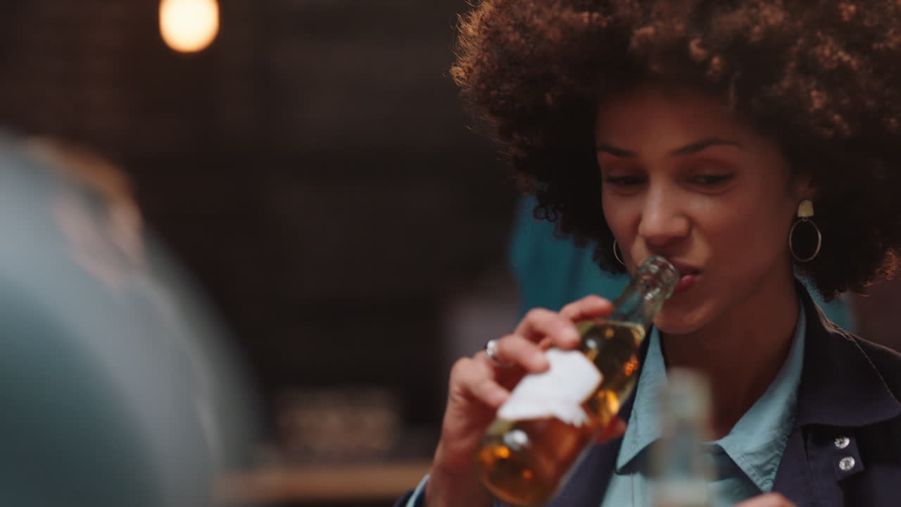 happy group of friends making toast having fun drinking socializing hanging out at pub chatting sharing celebration enjoying evening reunion gathering