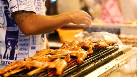 vendor grilling chicken at floating market stall