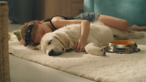 girl and puppy sleeping together