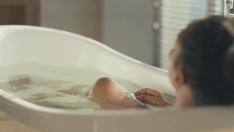 woman enjoying a relaxing bath and leg care