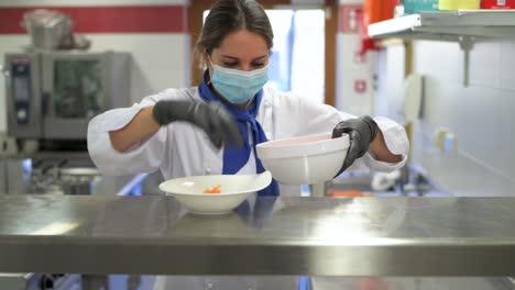 chef with face mask prepares a plate with carrots