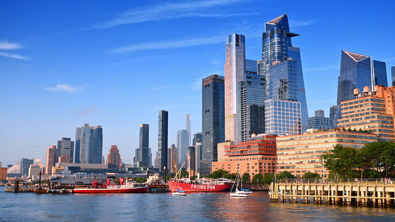 Approaching diverse boats at the pier of New York, USA. Low angle view at the stunning high-rise modern buildings in the city skyline