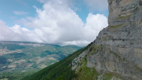 Highview-of-rockwall-and-valley-with-mighty-clouds,-Mount-Granier,-France