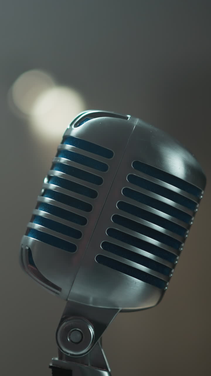 Sophisticated vintage microphone elegantly isolated against a blurred background with dynamic camera movement