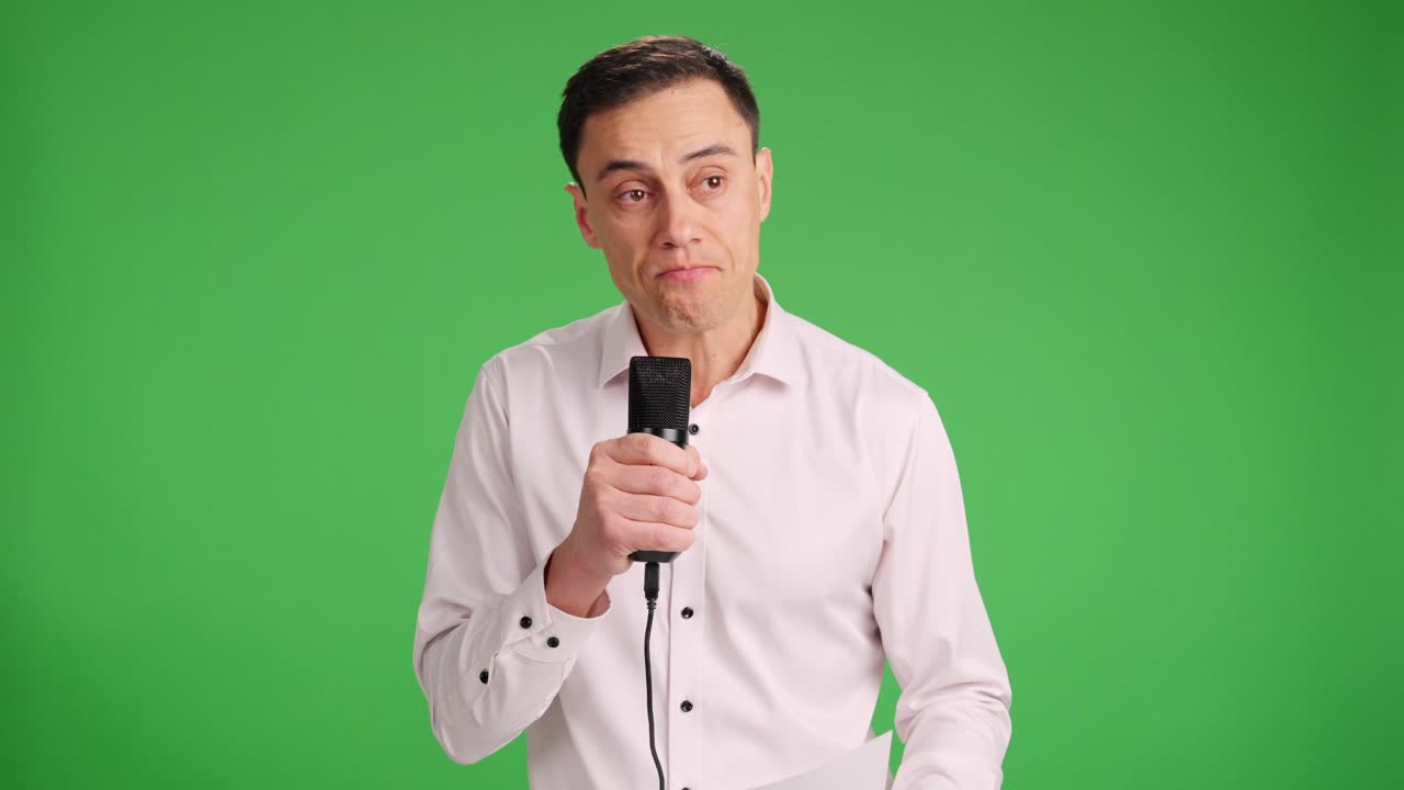 Man with microphone in hand gives emotional speech through tears