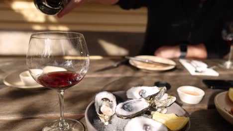 red wine being poured over oysters