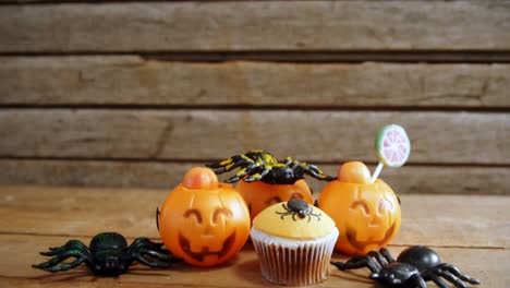 Halloween-spider-cupcake-on-a-wooden-table-4k