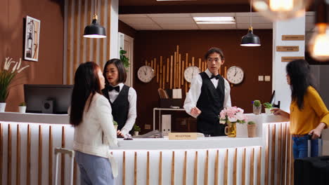 employees team greeting two women at five star hotel