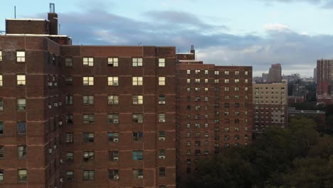 close aerial pan through housing project buildings in east harlem new york city in the early morning