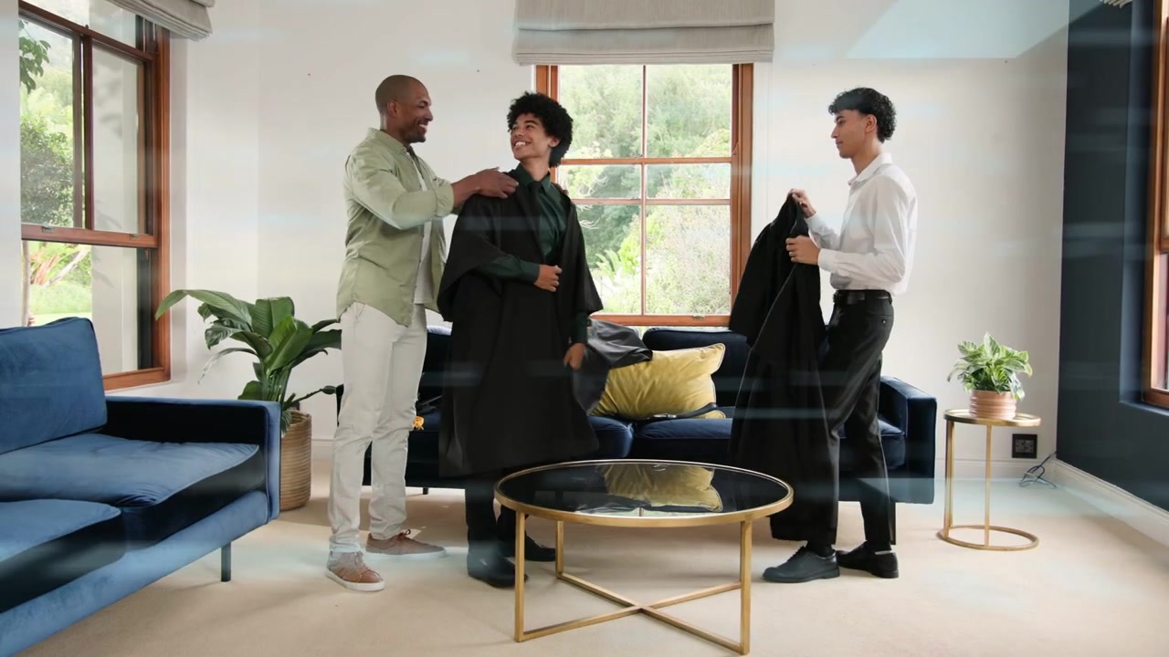 Two men unfolding black garments, causing binary overlay flowing, assistant draping for styling fit