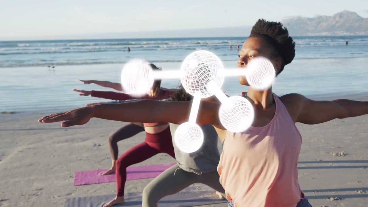 Lead woman guiding group holding yoga pose on beach camera zooming 3D molecule pulsing over group