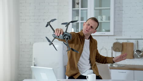 man holding drone at home. man showing the devices for aerial footage
