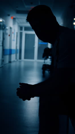 man sitting in hospital corridor