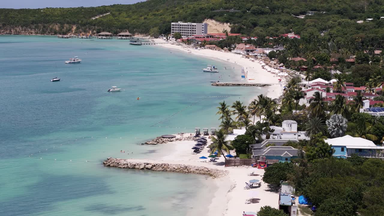 Beachfront Holiday Resort Town Along Dickenson Bay In Antigua and Barbuda. Aerial Drone Shot