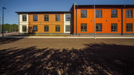 static shot of empty school ground with the view of school buildings int he background in timelapse