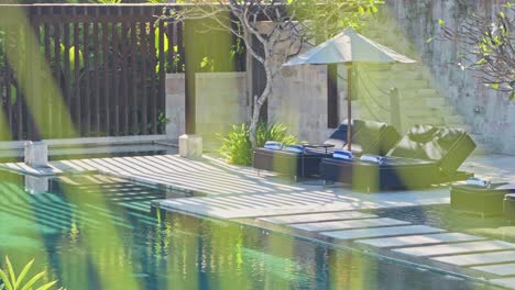 luxury sun loungers with the afternoon sun glow beaming down on them around the pool