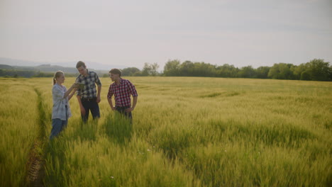 farmers inspecting wheat field with tablet