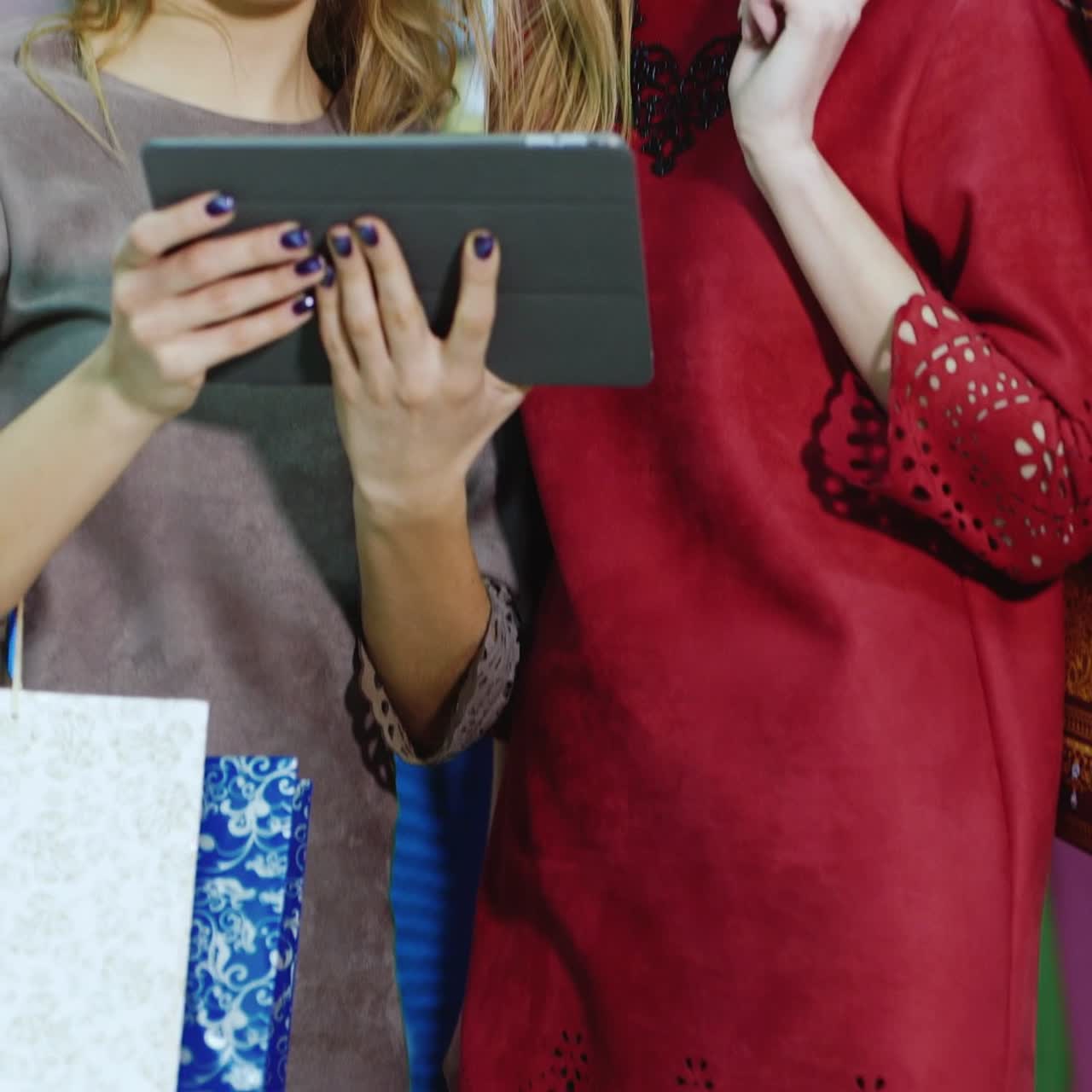Clothing Store: Female Visual Merchandising Specialist Uses Tablet Computer To Create Stylish Collection