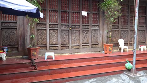 a dog wanders and sniffs around a serene courtyard.