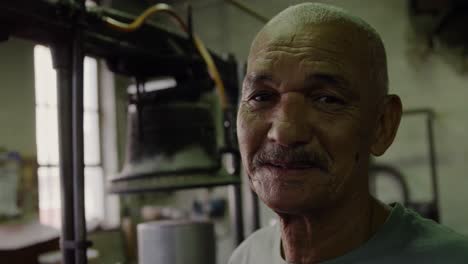 mixed race man working at a hat factory