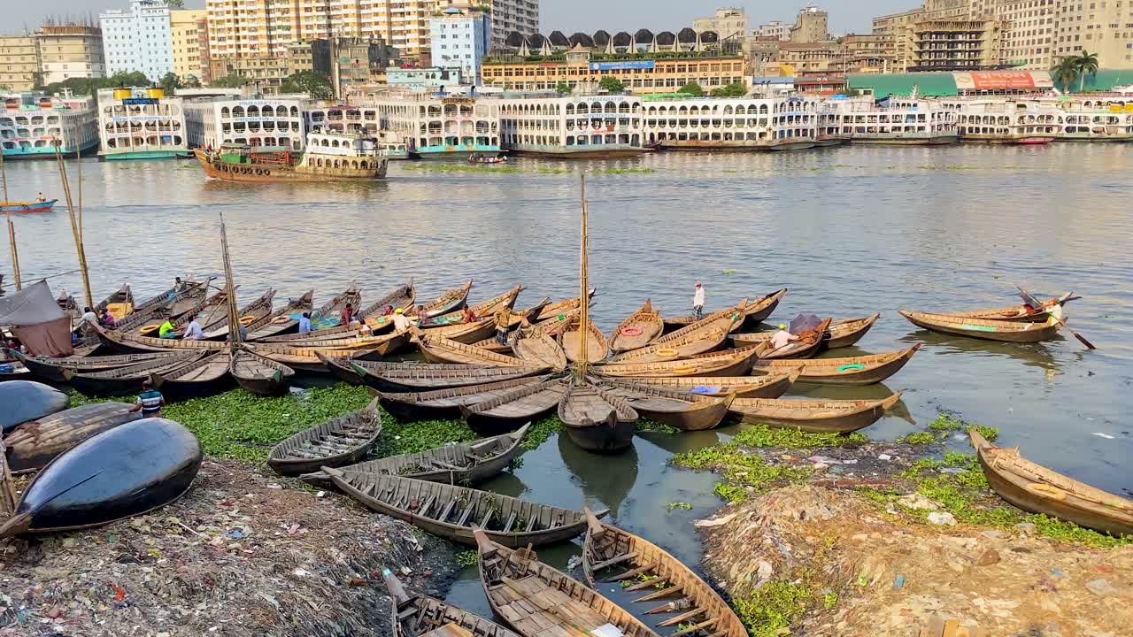 Boats floating on Buriganga River. Sewage water polluting the river in Dhaka city, Bangladesh