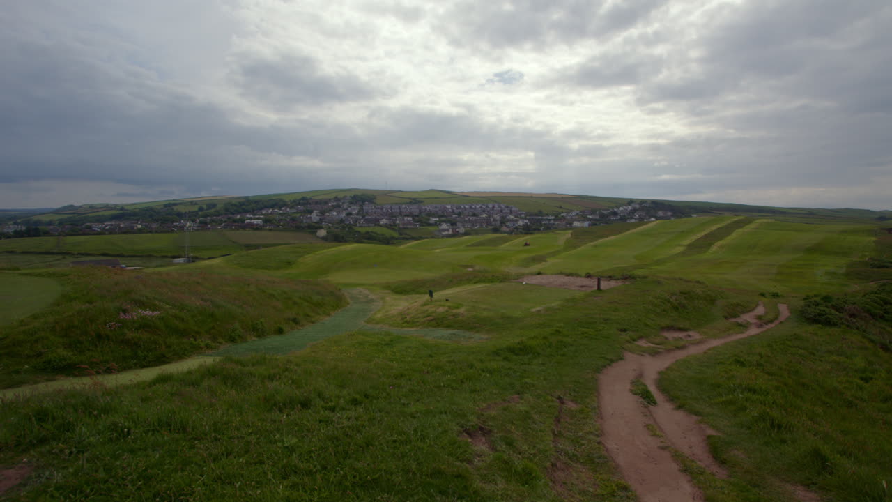 Extra Wide shot of St bees Golf Club with the village of St bees in background. West lake district