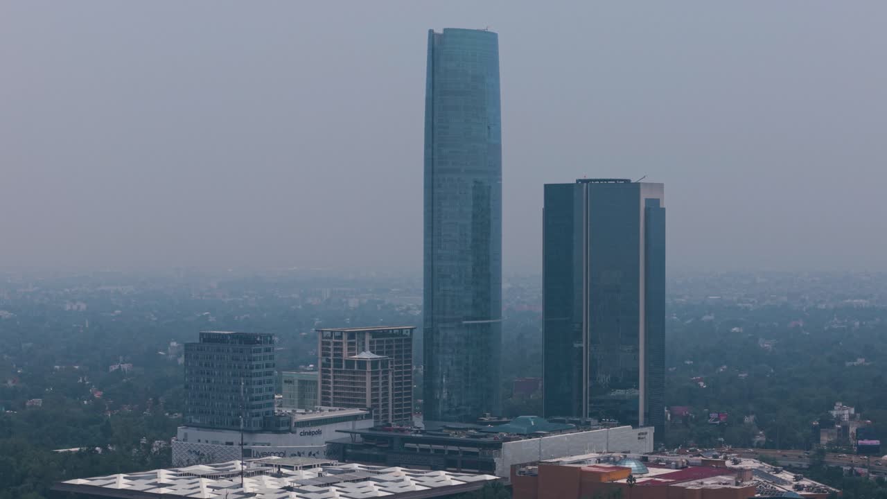 Elevated view of a pair of towers south of Mexico City, captured by a drone on a smoggy day