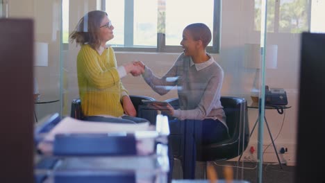 female colleagues discussing over the digital tablet 4k