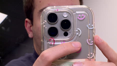 person holding a smartphone with a clear case