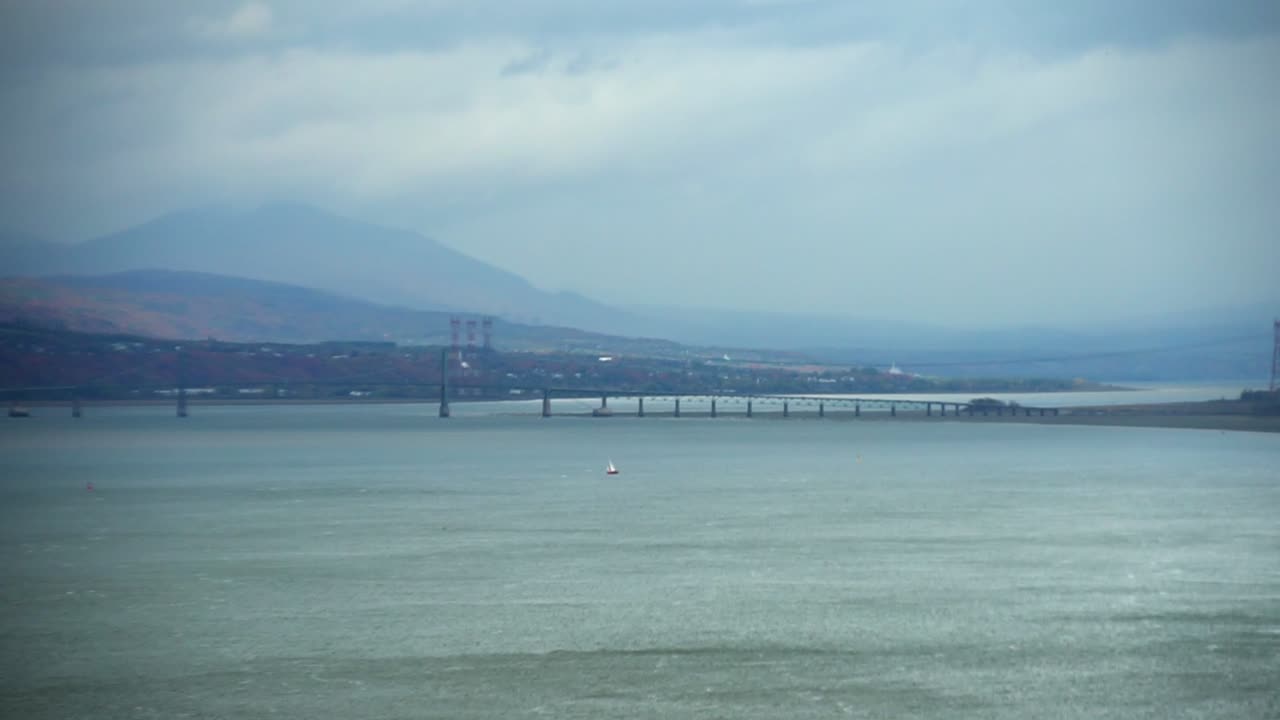 overcast sky and dark clouds over simmering waters of a beautiful harbor