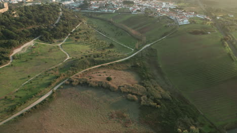 Road-Through-Medieval-Village-And-Castle-On-Meadow-Landscape-In-Obidos,-Portugal