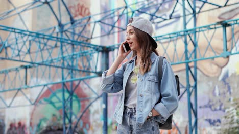 close-up view of caucasian woman in hipster style talking on the smartphone and spending time outdoors