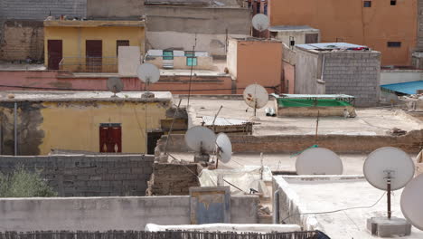 static video of the rudimentary rooftops of houses with parabolic antennas in moroccan city