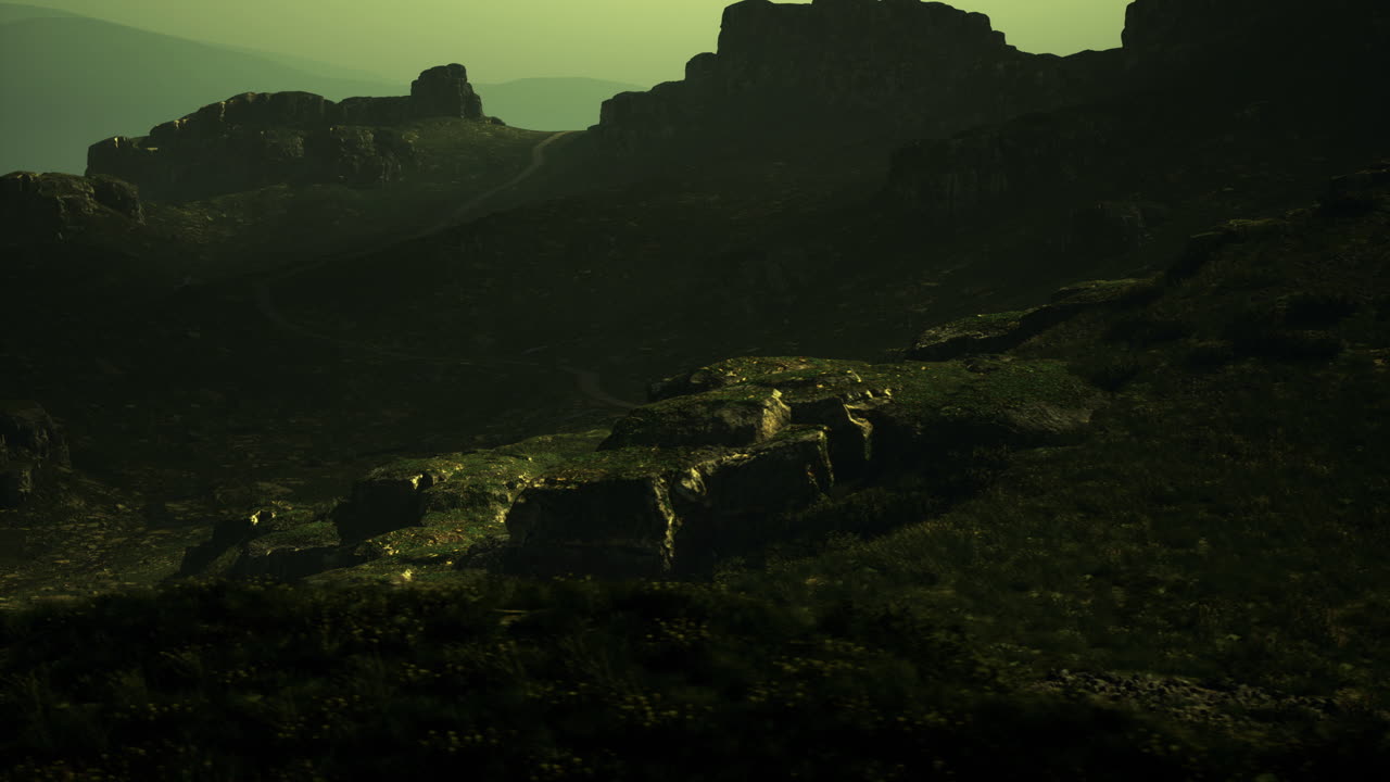 Landscape featuring rocky formations in a misty atmosphere during dusk
