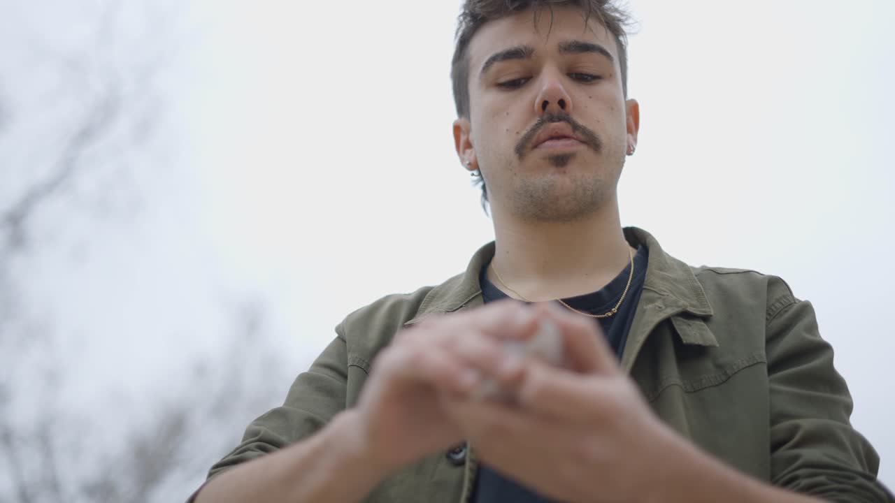 Young man performing a card trick